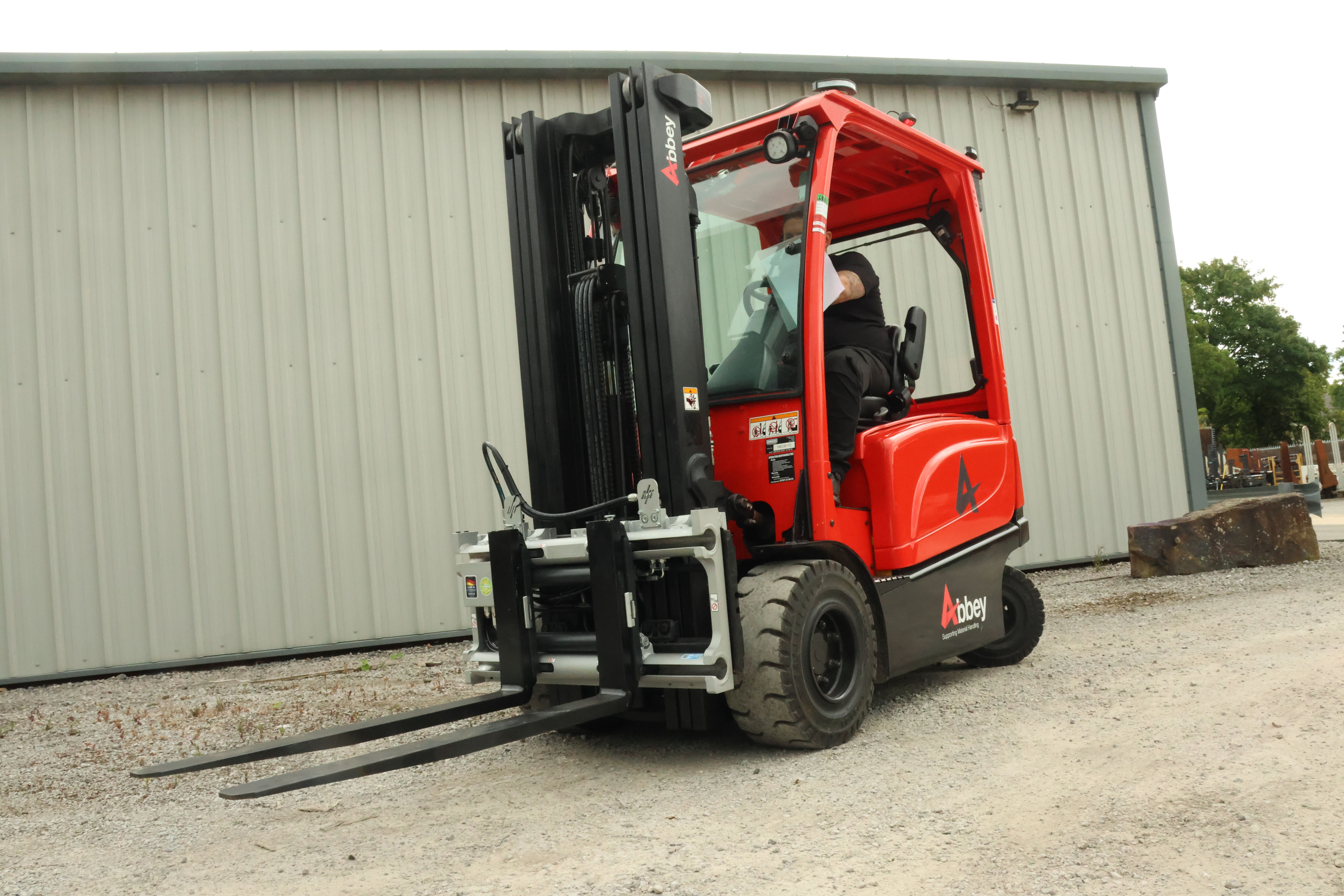 A Durwen fork positioner can seen fitted onto the red Abbey forklift truck