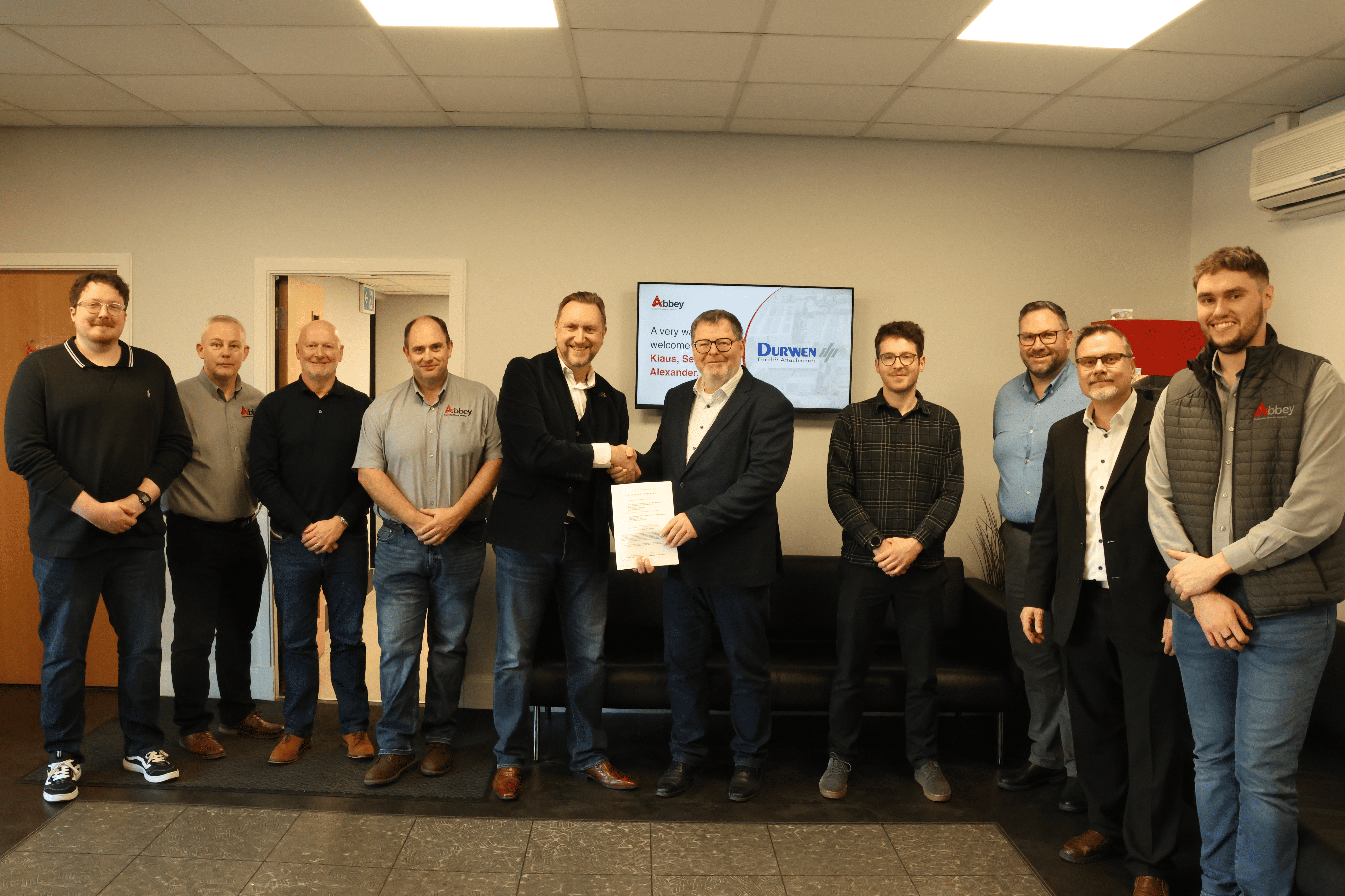 the staff of abbey and and durwen are holding up a partnership agreement