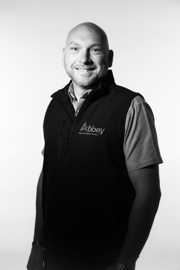 scott darbyshire is wearing an abbey branded gillet whilst smiling at the camera