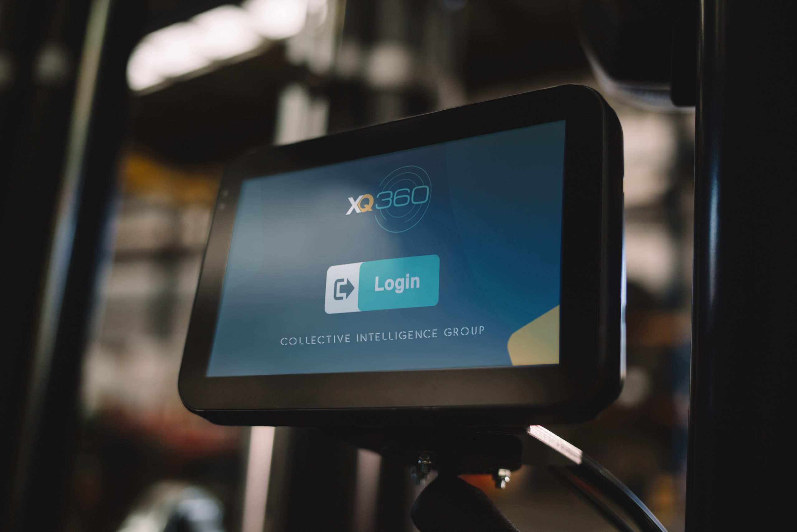 the login page for the xq360 forklift telematics system is displayed on touchscreen monitor within a forklift truck