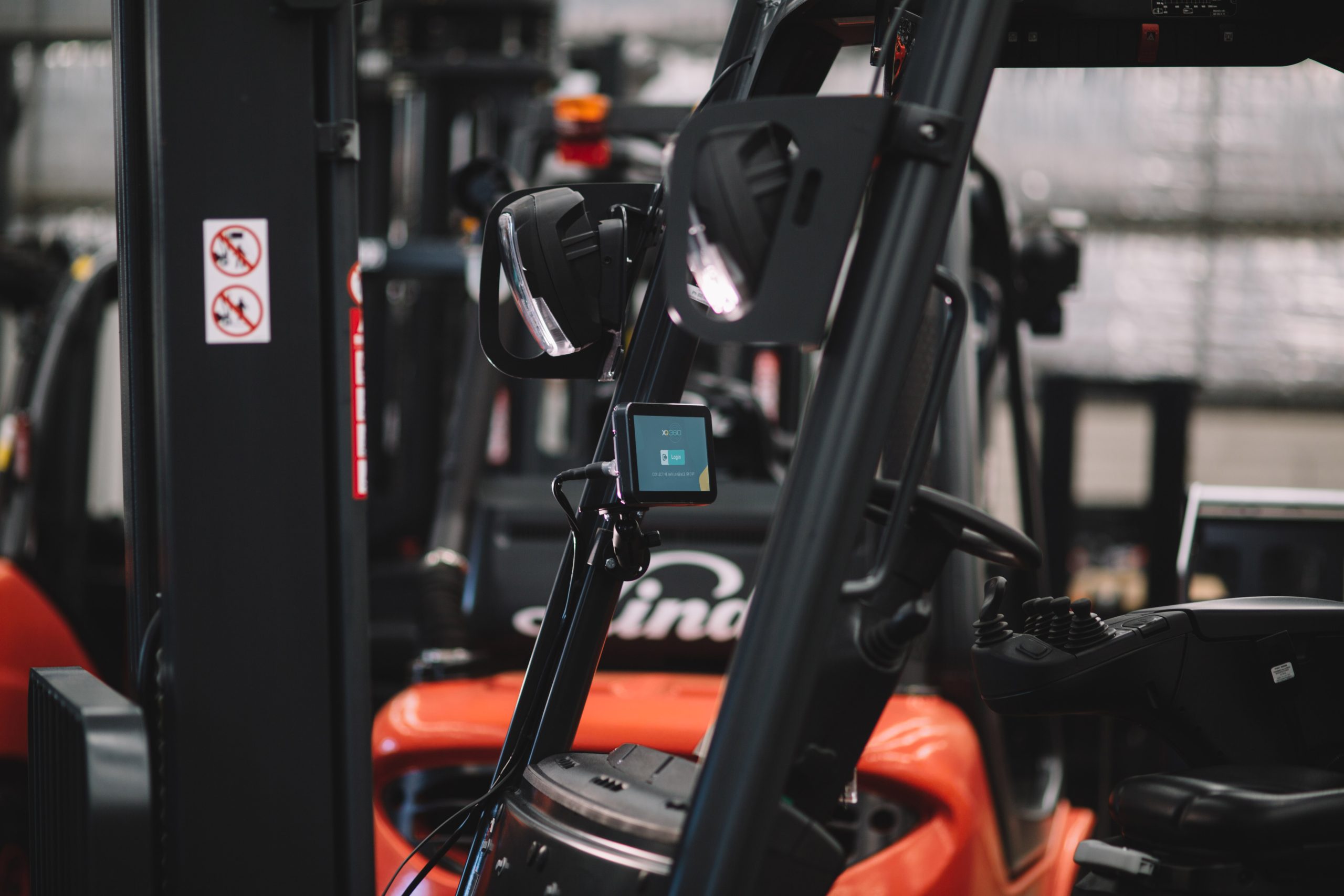 a touchscreen monitor can be seen from distance, within a forklift truck while presenting the login page for the xq360 forklift telematics system