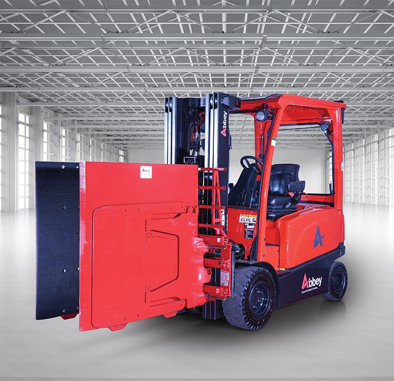 an abbey forktruck with a carton clamp is in the middle of an empty, white warehouse