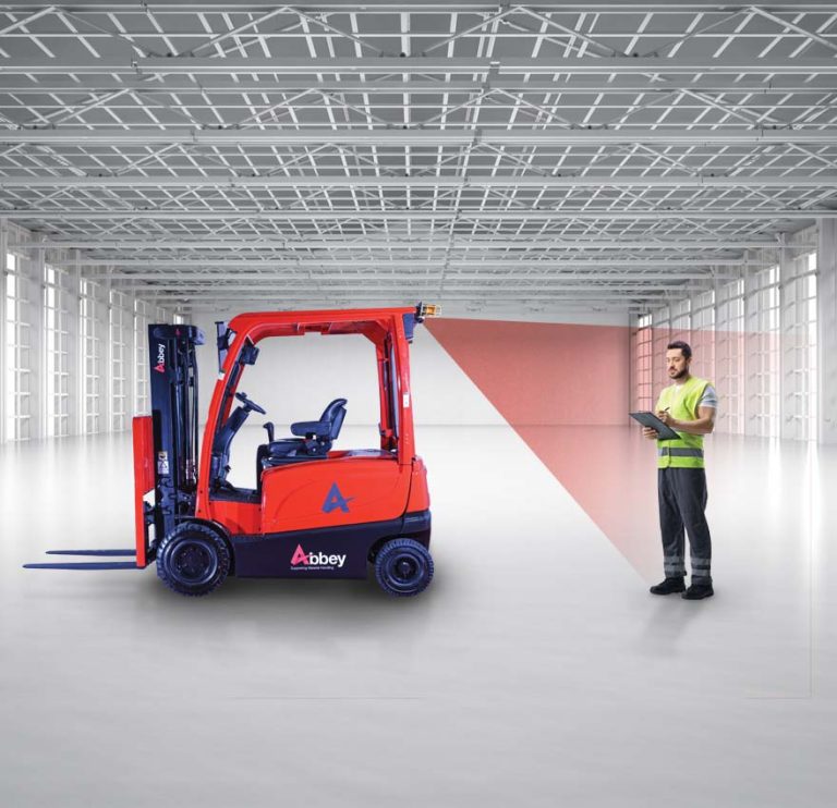 an abbey forklift truck with a red radar light projecting onto a warehouse worker wearing a yellow hi-vis jacket