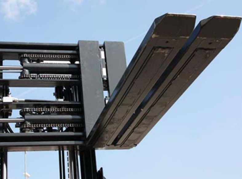 a low angle shot of the kooi® reachforks attached to a black forklift frame