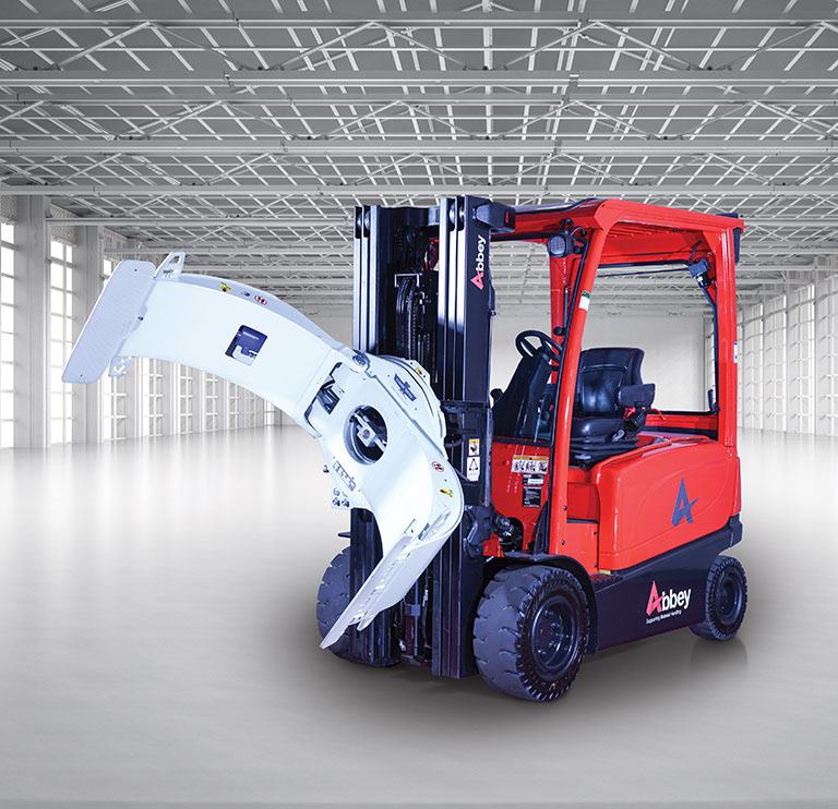 an abbey forktruck with a paper roll clamp is in the middle of an empty, white warehouse