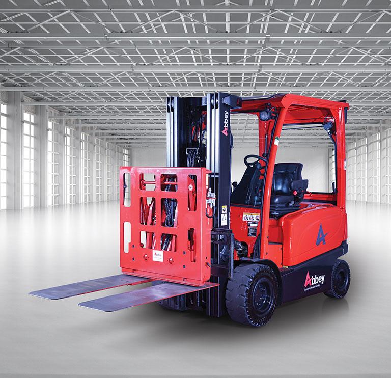 an abbey forktruck with a push and pull attachment is in the middle of an empty, white warehouse
