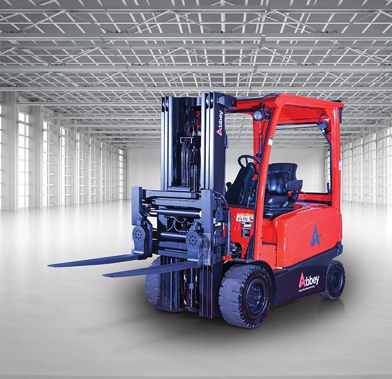 an abbey forktruck with a turn a fork attachment is in the middle of an empty, white warehouse